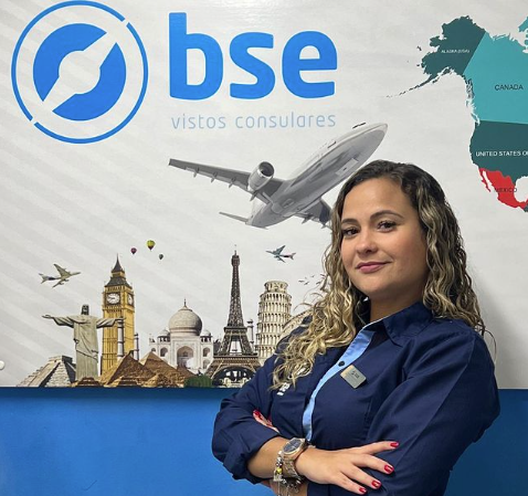 a woman standing in front of a poster