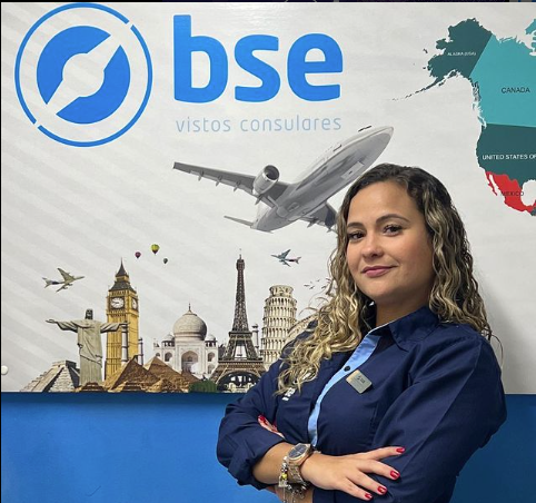 a woman standing in front of a poster